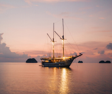 boat-at-late-afternoon A ship sailing in the waters at dusk